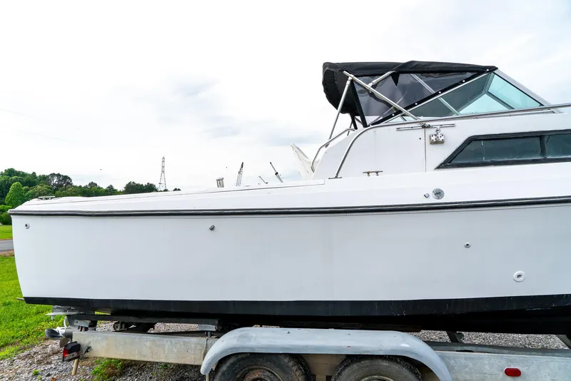 Slide: The Image of 1986 Aquasport 250 Express Fisherman boat on trailer, side view. - 6