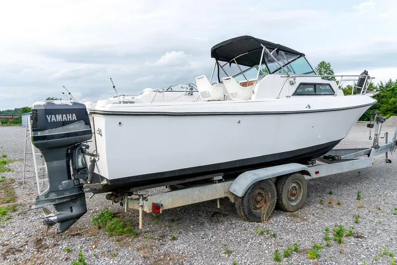 Slide: The Image of 1986 Aquasport 250 Express Fisherman boat on trailer with Yamaha outboard motor. - 7