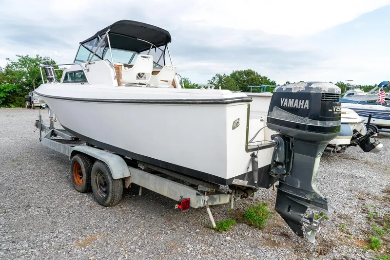 Slide: The Image of 1986 Aquasport 250 Express Fisherman boat on trailer with Yamaha outboard motor. - 9