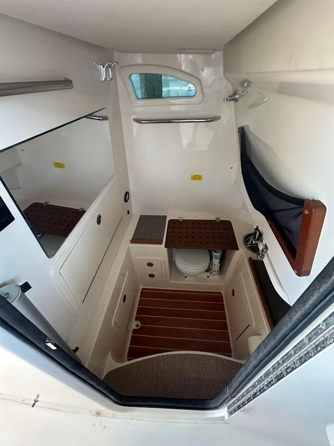 Slide: The Image of 2020 Grady-White Canyon 306 boat cabin interior with compact amenities. - 12