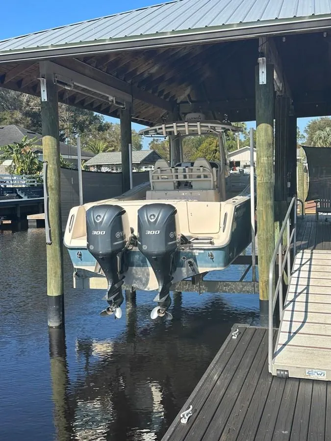 Slide: The Image of 2020 Grady-White Canyon 306 boat with dual engines docked in a covered marina. - 3