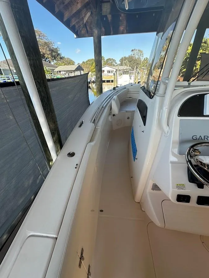 Slide: The Image of 2020 Grady-White Canyon 306 boat interior with steering console and dock view. - 6