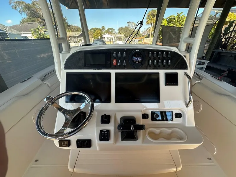 Slide: The Image of Cockpit of 2020 Grady-White Canyon 306 boat with steering wheel and control panel. - 7