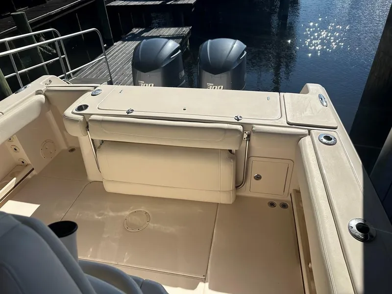 Slide: The Image of 2020 Grady-White Canyon 306 boat interior with dual outboard motors at dock. - 8