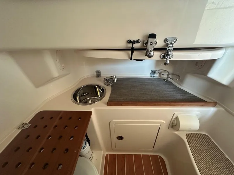 Slide: The Image of 2020 Grady-White Canyon 306 boat interior with sink and storage area. - 9