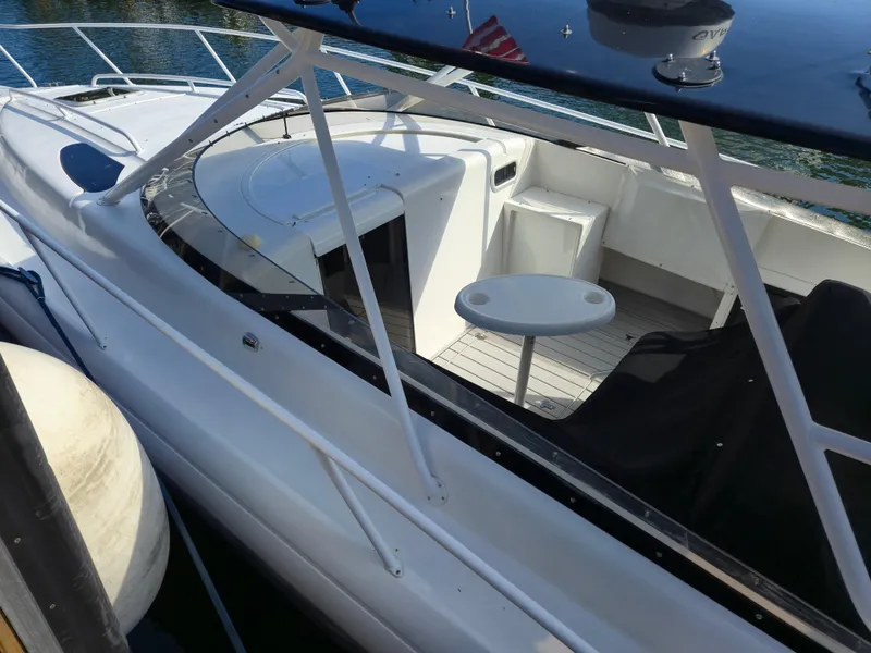 Slide: The Image of 2002 Intrepid 377 Walkaround boat with seating and table on deck. - 13