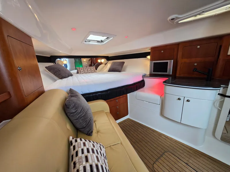 Slide: The Image of Interior of 2002 Intrepid 377 Walkaround boat with cozy bed, sofa, and kitchenette. - 15