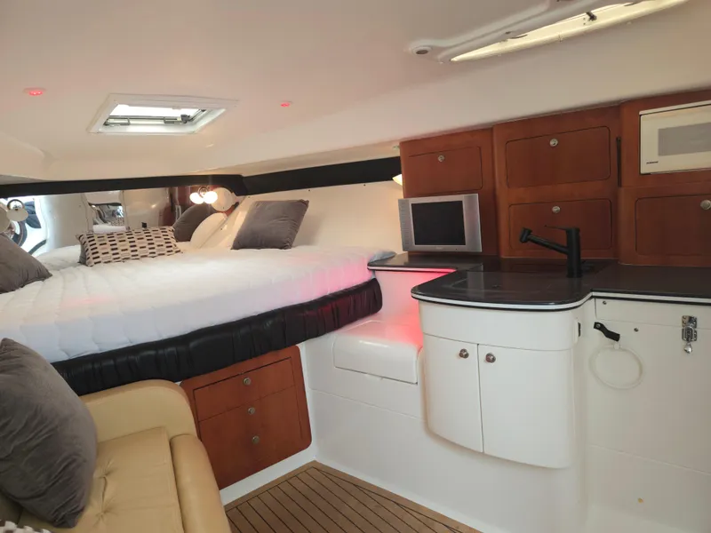 Slide: The Image of Interior of a 2002 Intrepid 377 Walkaround boat with cozy bed and kitchenette. - 18