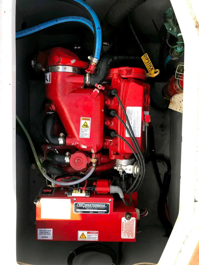 Slide: The Image of Engine compartment of a 2002 Intrepid 377 Walkaround boat, featuring a red Westerbeke engine. - 19