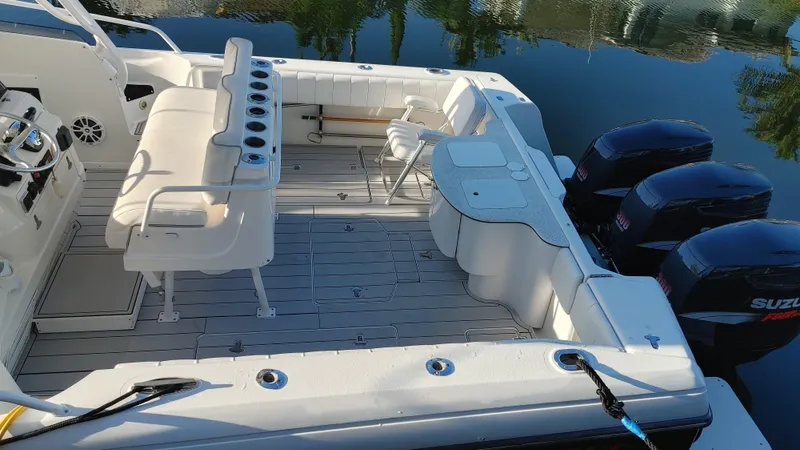 Slide: The Image of 2002 Intrepid 377 Walkaround boat with spacious deck and multiple outboard engines. - 6