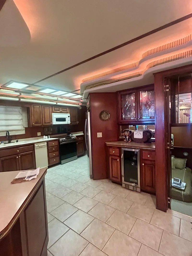 Slide: The Image of Luxurious Fantasy houseboat kitchen with modern appliances, wood cabinetry, and ambient lighting, 2001 model. - 10