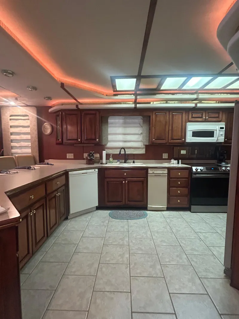 Slide: The Image of Spacious kitchen in 2001 Fantasy houseboat with modern appliances and warm lighting. - 11