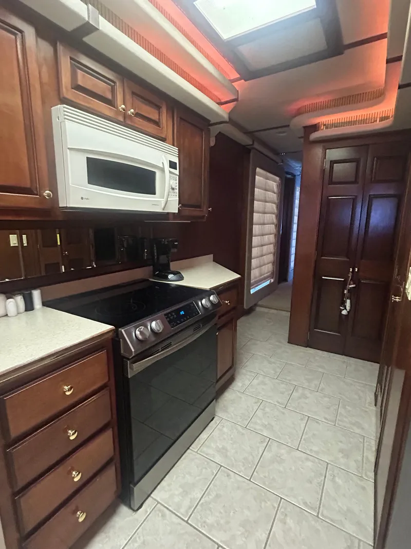 Slide: The Image of Luxurious kitchen in a 2001 Fantasy houseboat with wood cabinets and modern appliances. - 12