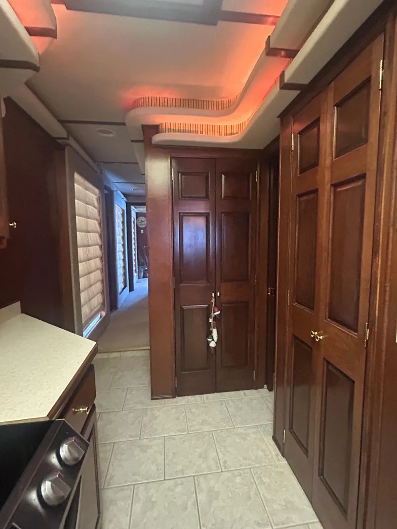 Slide: The Image of Luxurious 2001 Fantasy houseboat interior with wooden cabinets and modern lighting. - 13