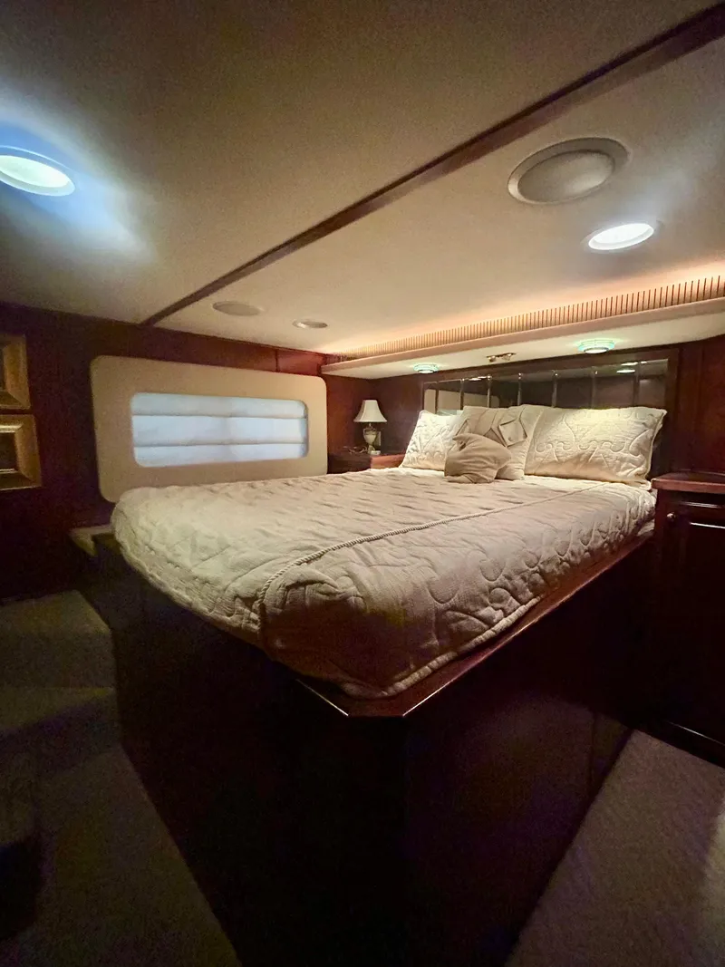 Slide: The Image of Cozy bedroom in a 2001 Fantasy houseboat with ambient lighting and plush bedding. - 15