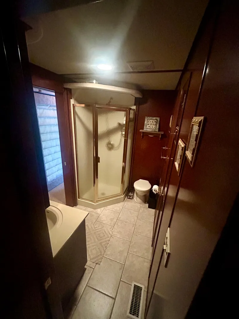 Slide: The Image of Compact bathroom in a 2001 Fantasy houseboat with shower, toilet, and sink. - 16
