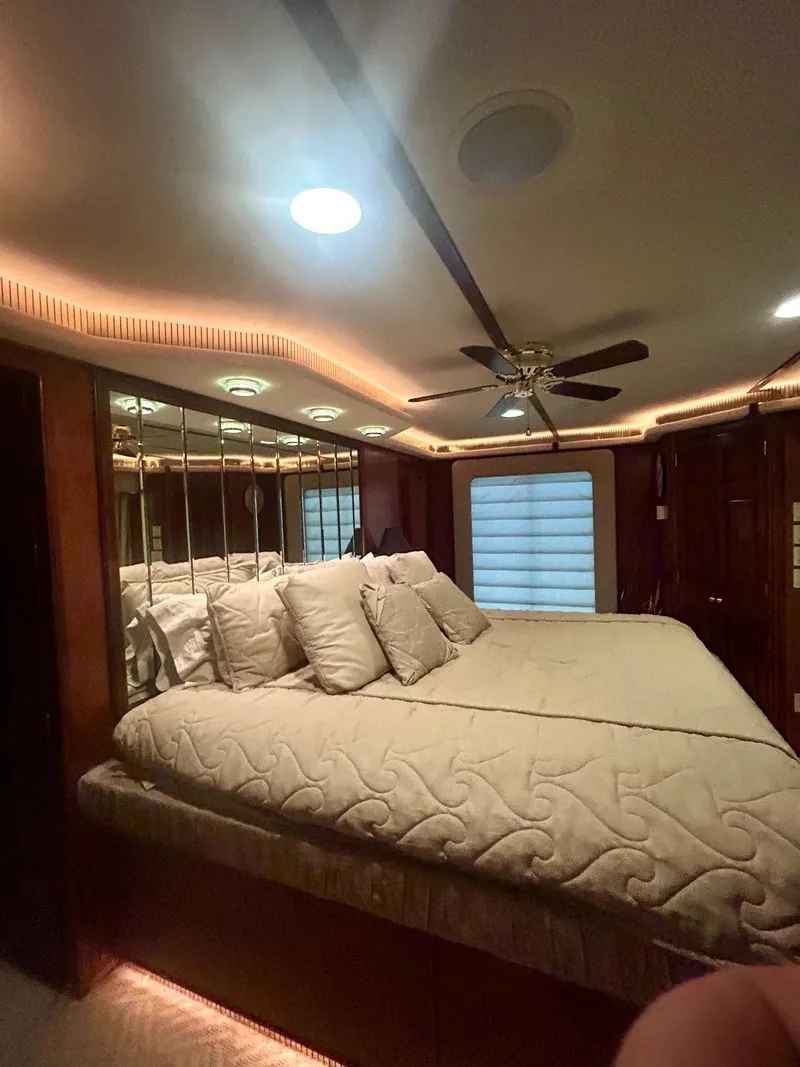 Slide: The Image of Luxurious bedroom interior in a 2001 Fantasy houseboat with ambient lighting and ceiling fan. - 20
