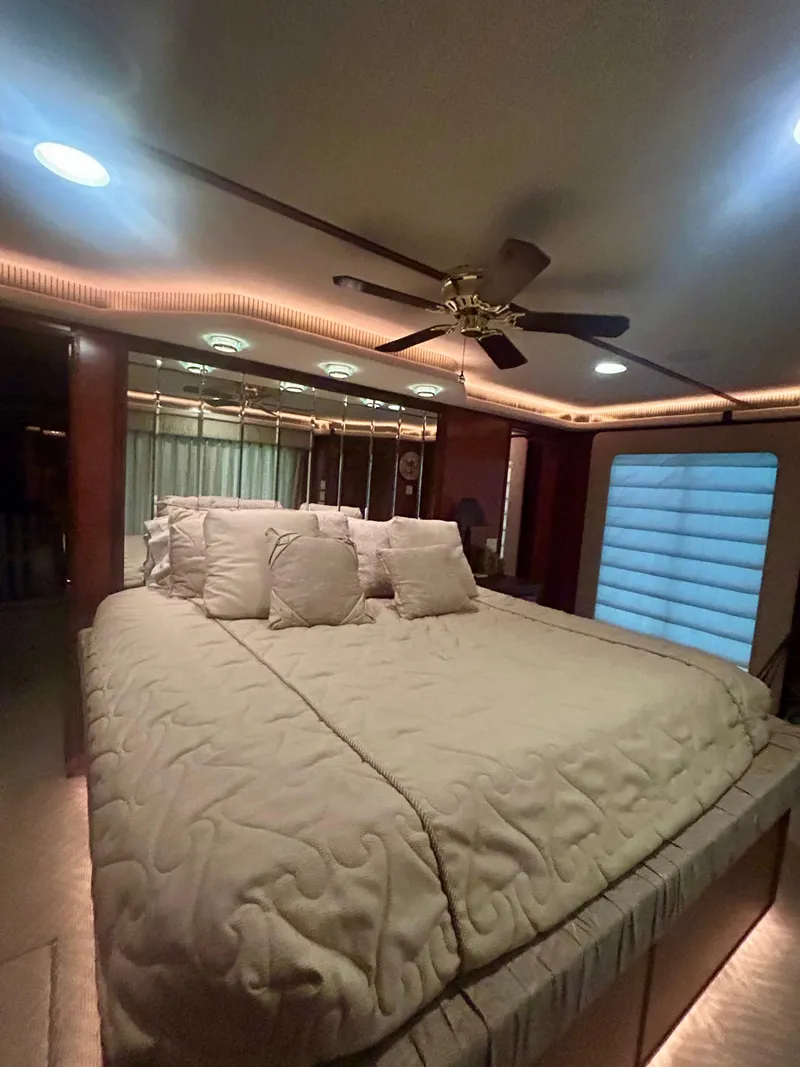 Slide: The Image of Luxurious bedroom interior in a 2001 Fantasy houseboat with elegant bedding and ambient lighting. - 21