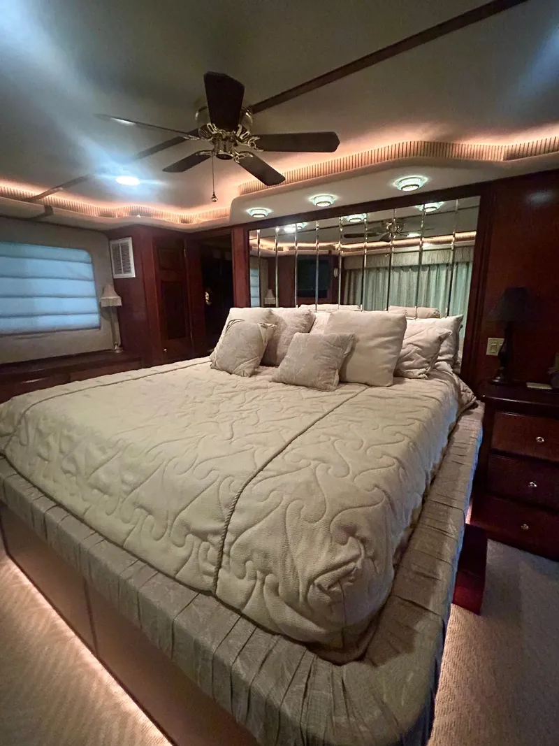 Slide: The Image of Luxurious bedroom in a 2001 Fantasy houseboat with elegant bedding and ambient lighting. - 22