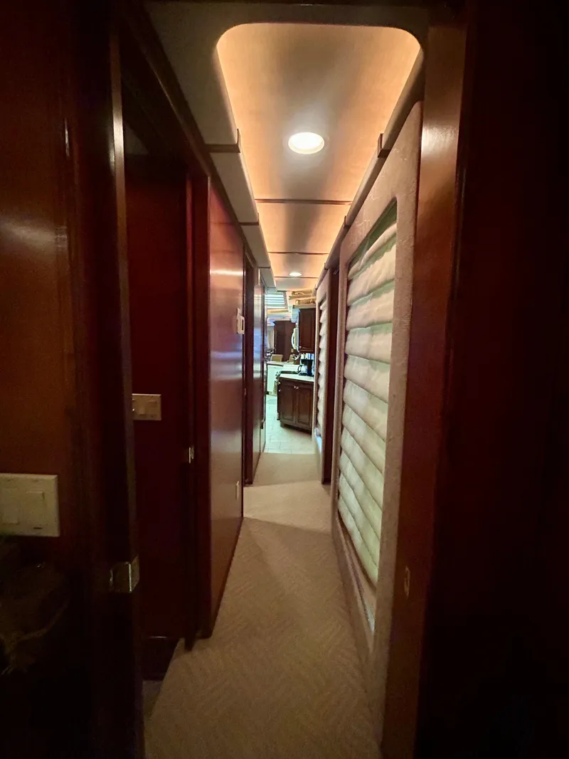 Slide: The Image of Narrow hallway inside a 2001 Fantasy houseboat, featuring warm lighting and modern design. - 25