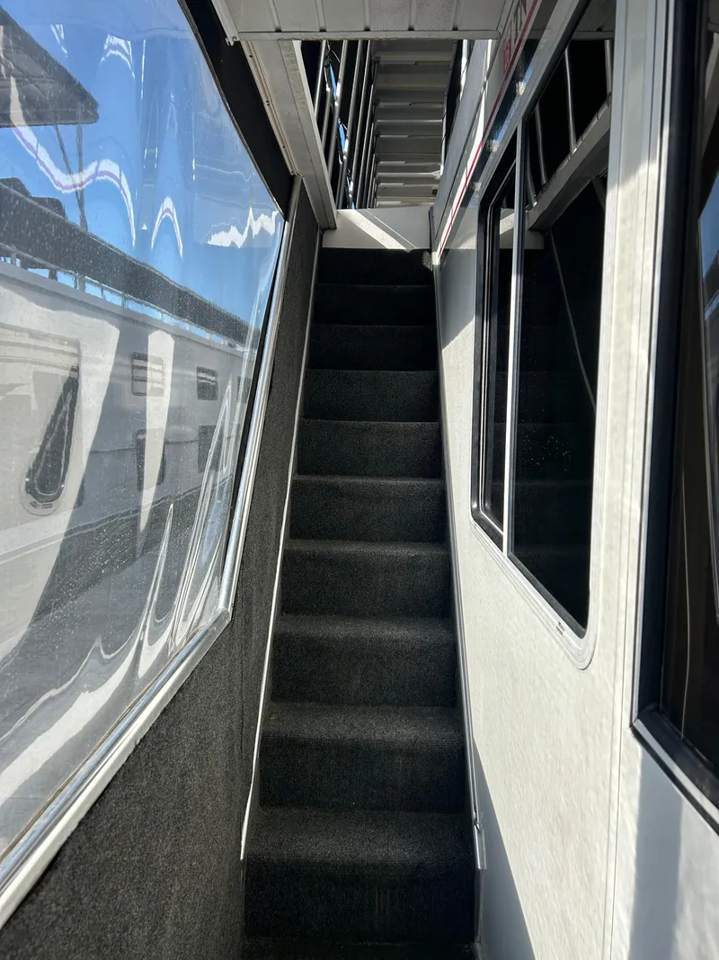 Slide: The Image of Staircase inside 2001 Fantasy houseboat with reflective windows and carpeted steps. - 27