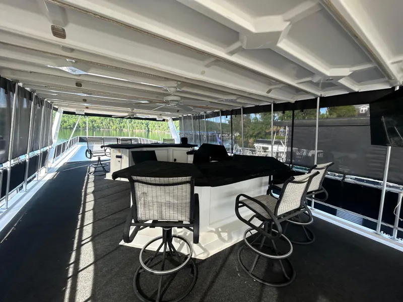 Slide: The Image of Spacious 2001 Fantasy houseboat deck with bar and seating, featuring modern design and natural light. - 30