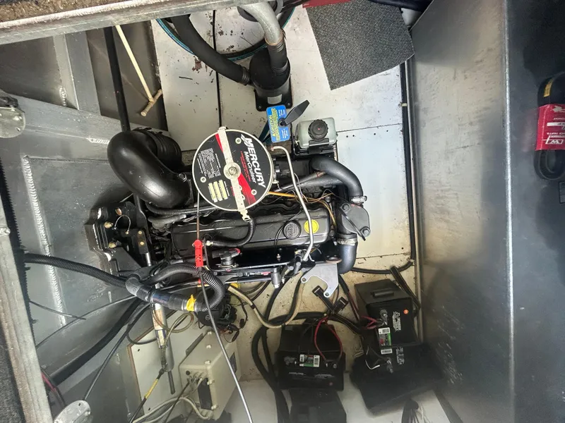 Slide: The Image of Engine compartment of a 2001 Fantasy Houseboat, featuring mechanical components and wiring. - 35