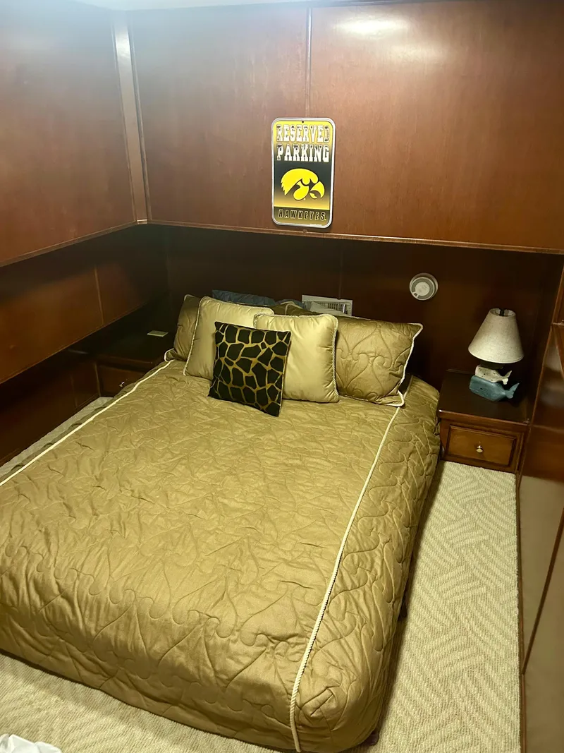 Slide: The Image of Cozy bedroom in 2001 Fantasy houseboat with wood paneling and decorative pillows. - 9