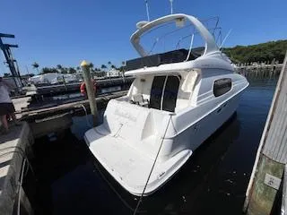 Slide: The Image of Interior of a 2001 Silverton 410 Sport Bridge yacht with cozy seating and modern amenities. - 10