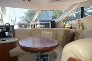 Slide: The Image of Interior of 2001 Silverton 410 Sport Bridge with cozy seating and modern amenities. - 3