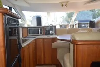 Slide: The Image of Interior of 2001 Silverton 410 Sport Bridge yacht with wood cabinetry and modern appliances. - 6