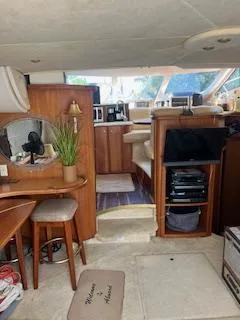 Slide: The Image of 2001 Silverton 410 Sport Bridge helm with gauges, steering wheel, and seating. - 9