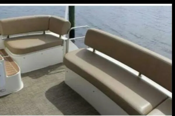 Slide: The Image of 2013 Carver C34 Command Bridge seating area with beige cushions, overlooking water. - 11