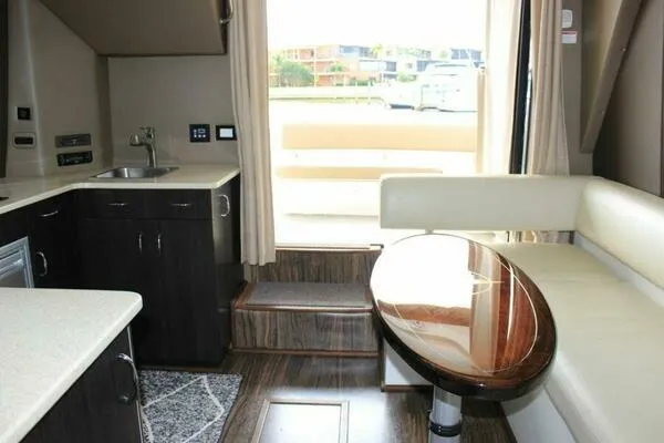 Slide: The Image of Interior of 2013 Carver C34 Command Bridge yacht with kitchenette and seating area. - 12