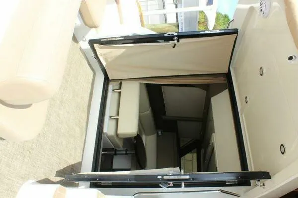 Slide: The Image of 2013 Carver C34 Command Bridge interior with beige seating and open cabin door. - 13