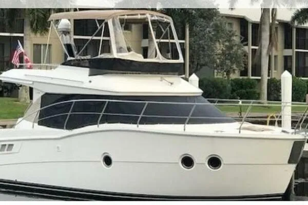 Slide: The Image of 2013 Carver C34 Command Bridge yacht docked near waterfront buildings. - 5