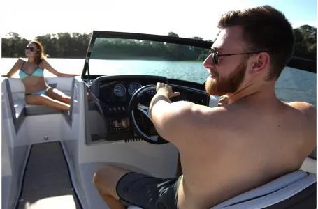 Slide: The Image of 2018 Monterey M205 Bowrider on a sunny lake outing with two people enjoying the ride. - 2