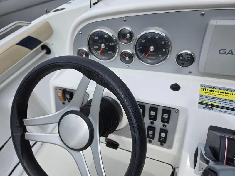 Slide: The Image of 2016 Godfrey Hurricane Sundeck SS211 Center Console dashboard with steering wheel and gauges. - 12