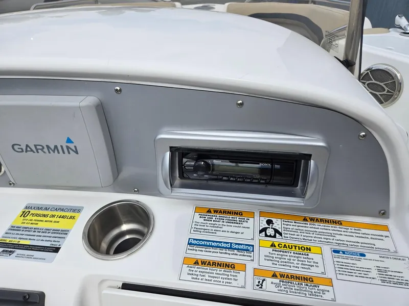 Slide: The Image of Control panel of 2016 Godfrey Hurricane Sundeck SS211 with Garmin system and warning labels. - 14