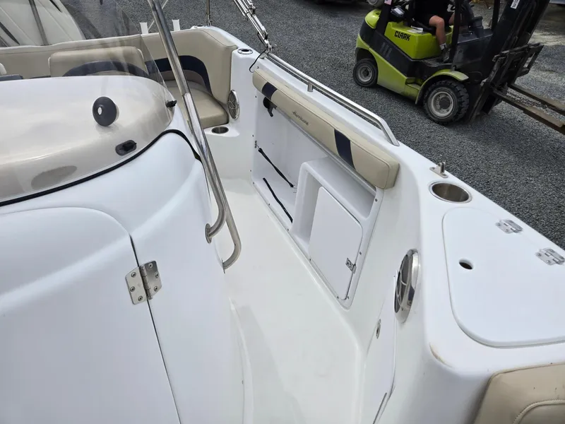 Slide: The Image of 2016 Godfrey Hurricane Sundeck SS211 Center Console boat interior with seating and storage. - 19
