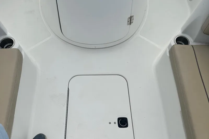 Slide: The Image of 2016 Godfrey Hurricane Sundeck SS211 Center Console interior with seating and storage compartments. - 22
