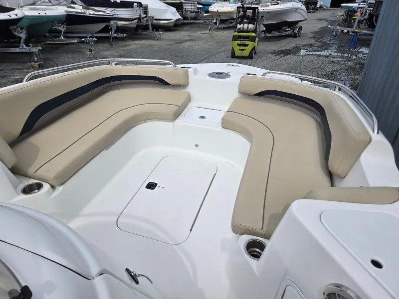 Slide: The Image of 2016 Godfrey Hurricane Sundeck SS211 Center Console with beige seating in a boatyard. - 27