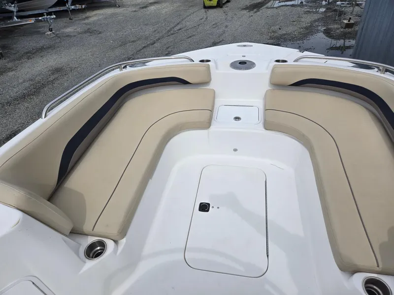 Slide: The Image of 2016 Godfrey Hurricane Sundeck SS211 Center Console with beige seating and storage compartments. - 28