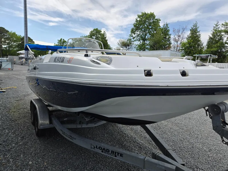 Slide: The Image of 2016 Godfrey Hurricane Sundeck SS211 Center Console boat on a trailer, parked outdoors. - 3