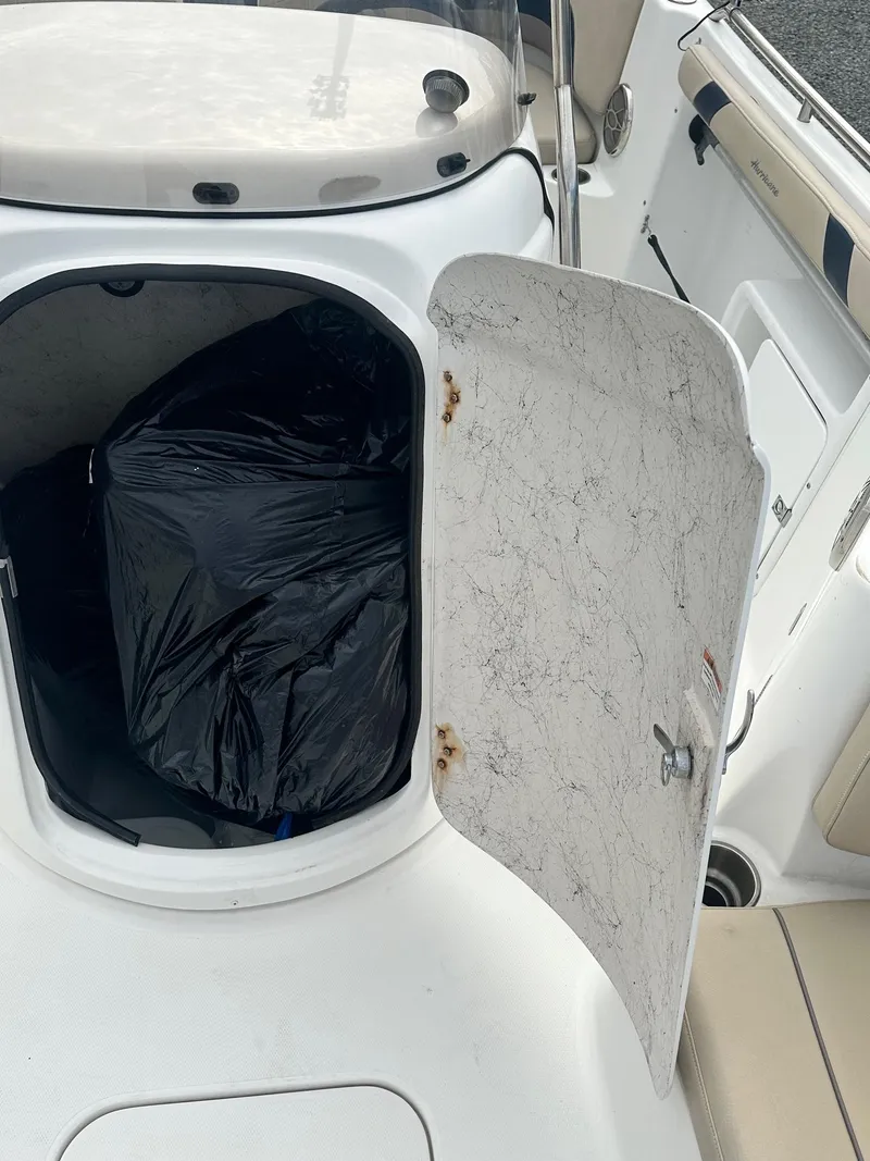 Slide: The Image of 2016 Godfrey Hurricane Sundeck SS211 Center Console storage compartment with open door. - 34