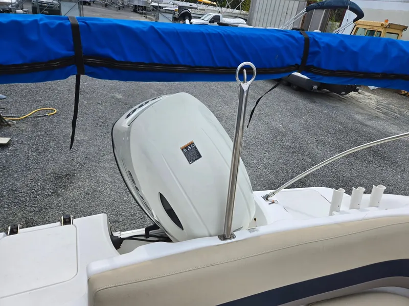 Slide: The Image of 2016 Godfrey Hurricane Sundeck SS211 Center Console with outboard motor and blue cover. - 35