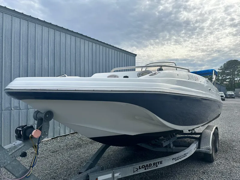 Slide: The Image of 2016 Godfrey Hurricane Sundeck SS211 Center Console boat on trailer, parked outdoors. - 4