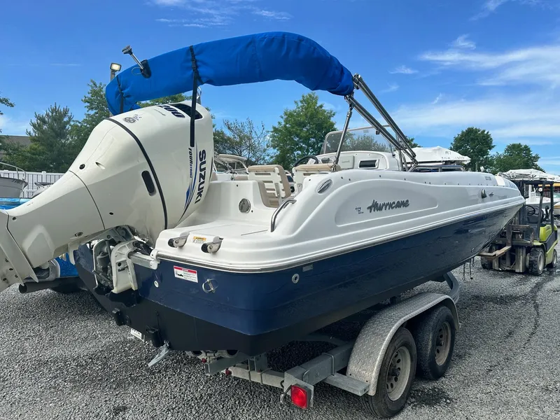 Slide: The Image of 2016 Godfrey Hurricane Sundeck SS211 Center Console boat on trailer, blue and white design. - 7