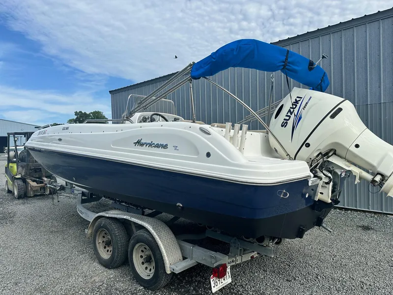 Slide: The Image of 2016 Godfrey Hurricane Sundeck SS211 Center Console boat on trailer, blue and white design. - 8