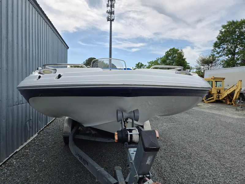 Slide: The Image of 2016 Godfrey Hurricane Sundeck SS211 Center Console boat on trailer, parked outdoors. - 9